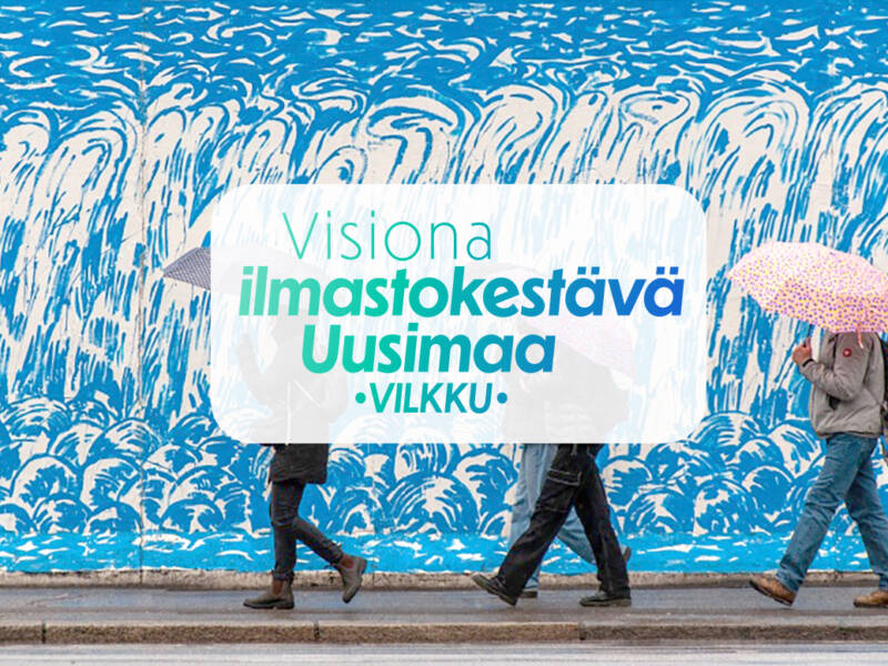 Ihmisiä kävelemässä sateenvarjojen kanssa. Teksti Visiona ilmastokestävä Uusimaa VILKKU.