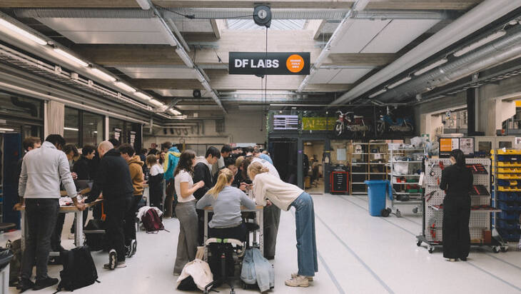 A large group of people workshopping at the Aalto Design Factory.