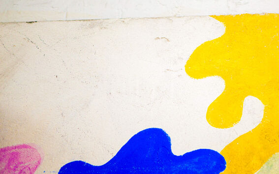 A wall with painted abstract illustrations.