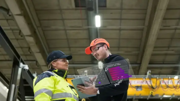 Two people at a logistics warehouse.