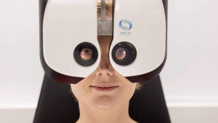 A person photographed through an optical medical device.